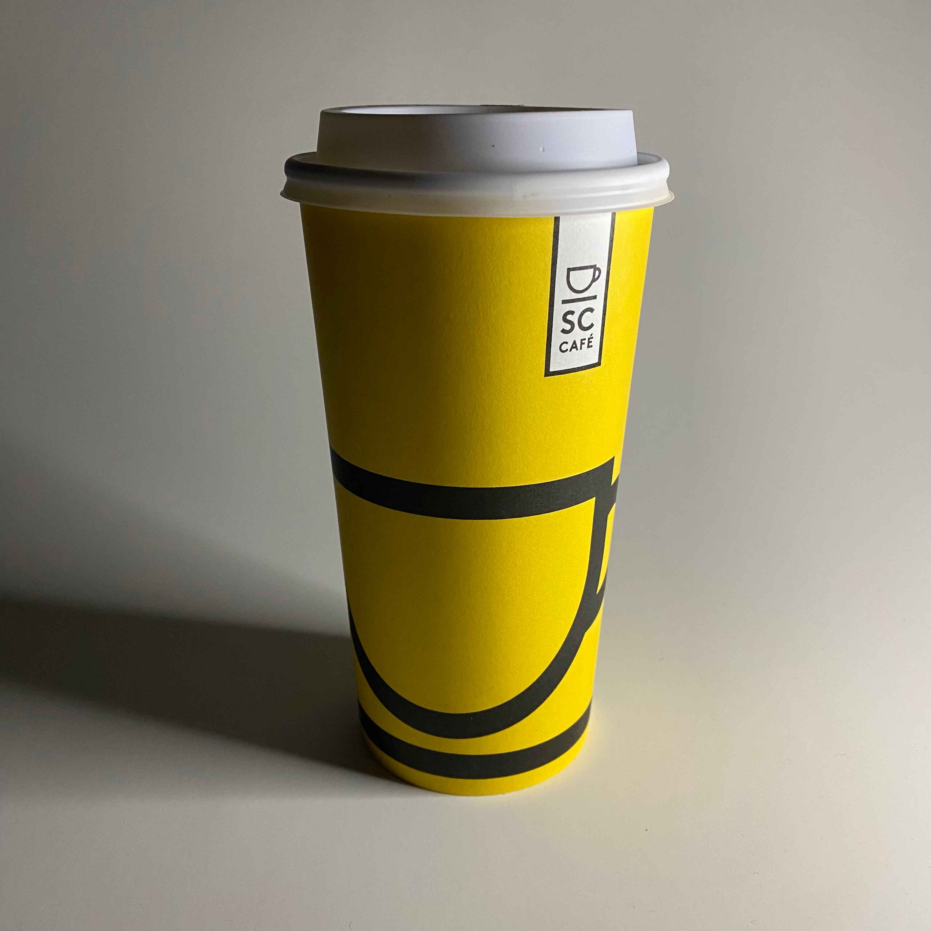 Front shot of the coffee cup up-close, showing the back view